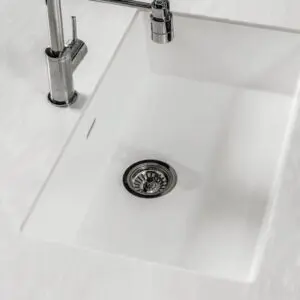 White kitchen sink with chrome faucet