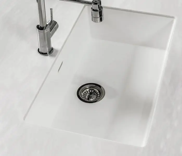 White kitchen sink with chrome faucet