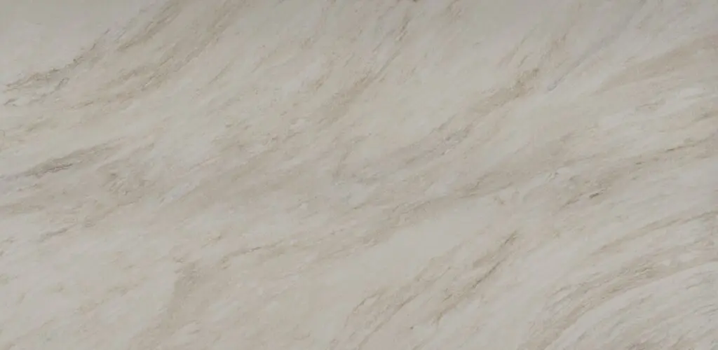 Beige marble surface with natural veins and patterns.