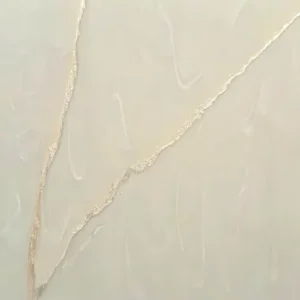 Beige plaster wall with gold veined cracks